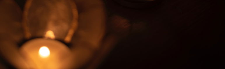close up image of two candle flames in lotus flower candle holders