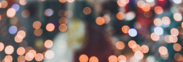 close up of blurry lights with figure of a human in the background