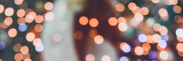 close up of blurry lights with figure of a human in the background