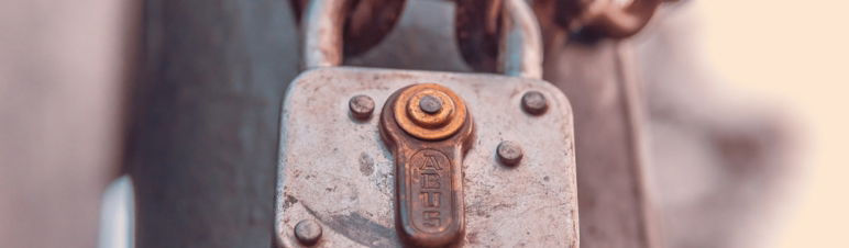 close up image of padlock attached to two ends of a chain